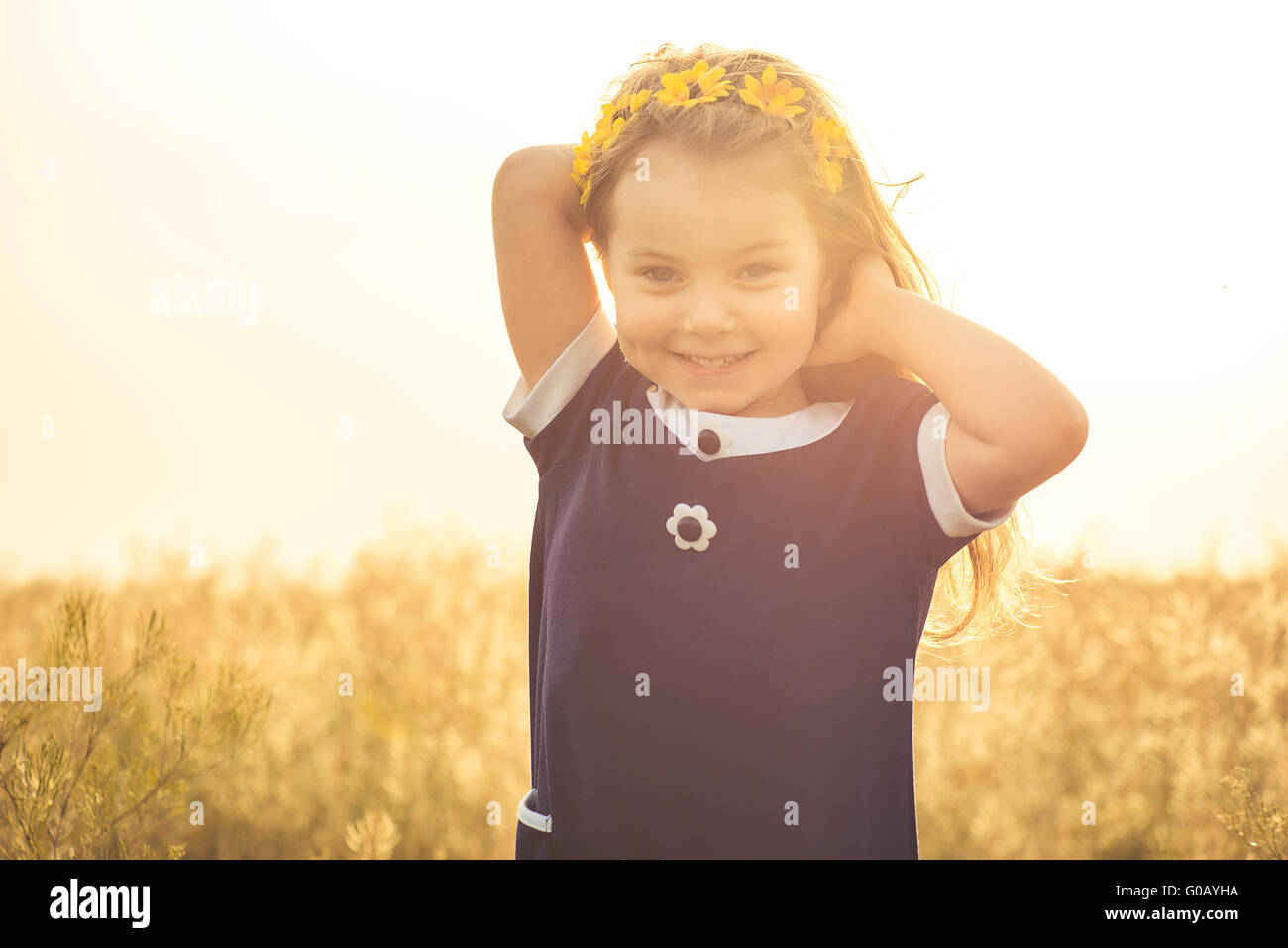 the beautiful little girl in a blue dress laughs Stock Photo - Alamy