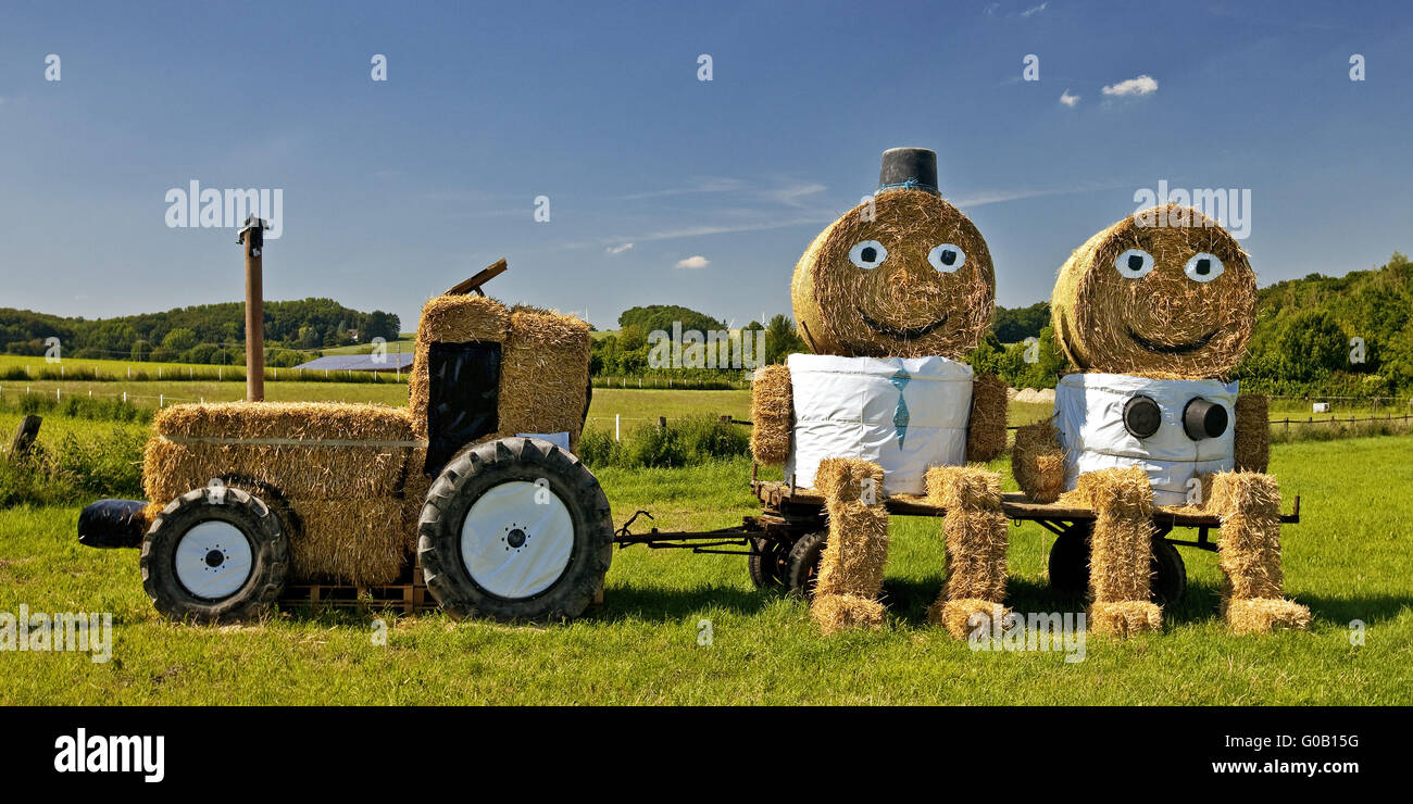 Tractor and pair of straw bales, Coesfeld, Germany Stock Photo