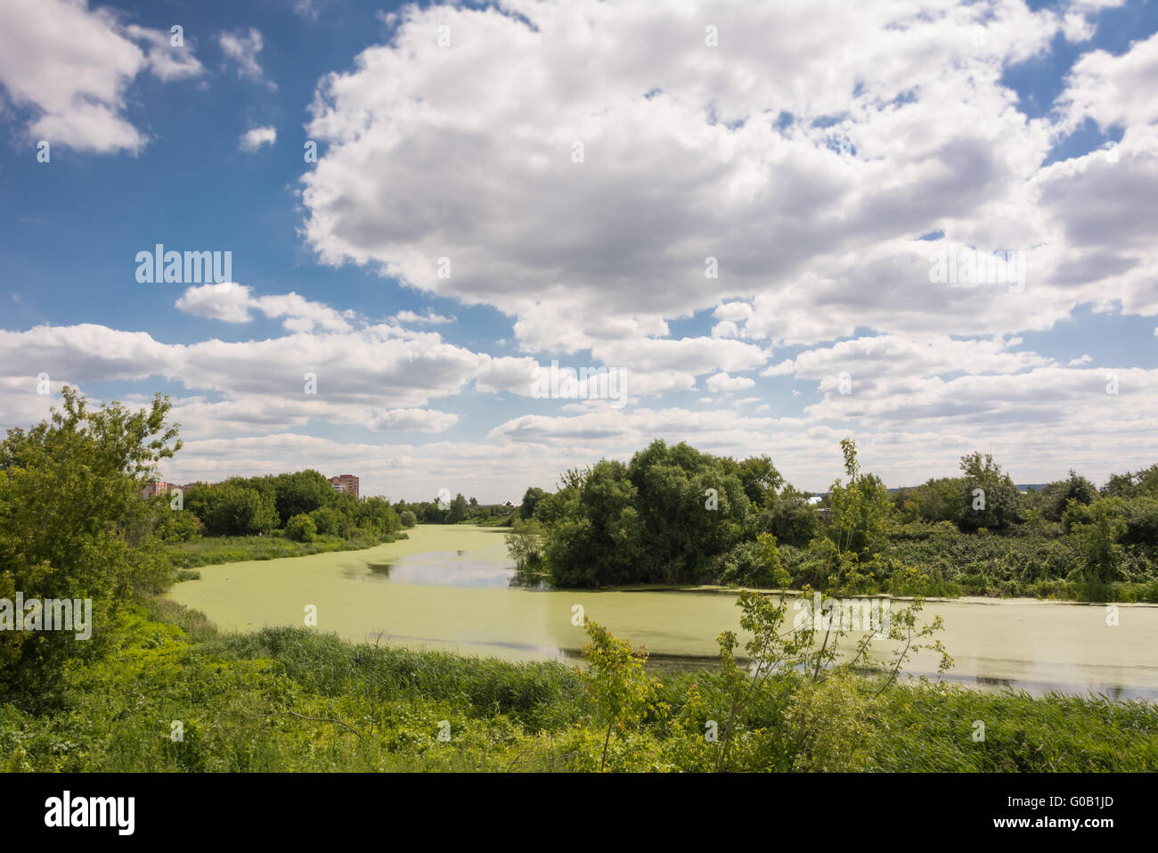 Suburban landscape with river and blue sky Stock Photo