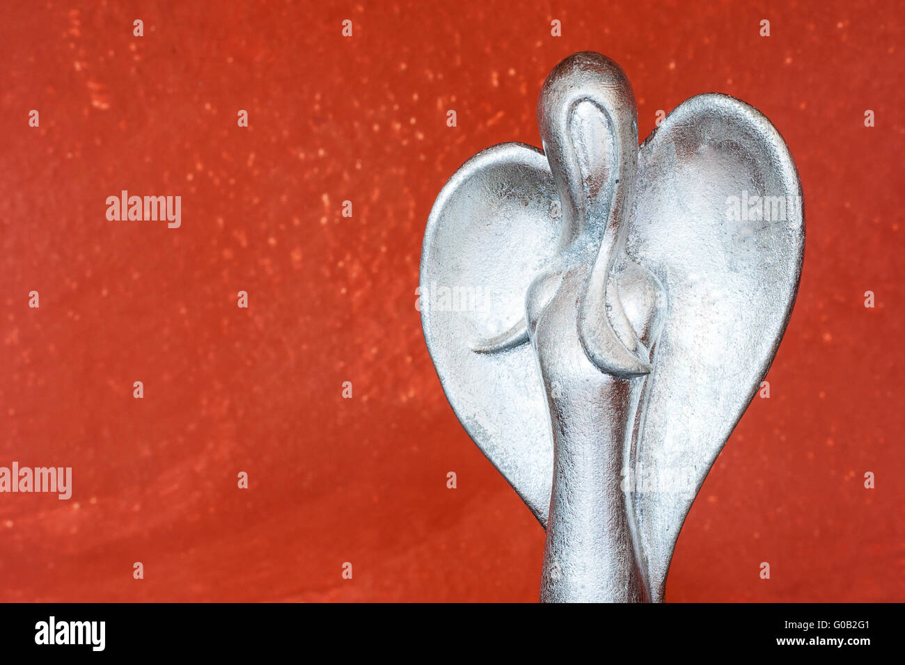 Upper body of a silver angel figure in front of te Stock Photo