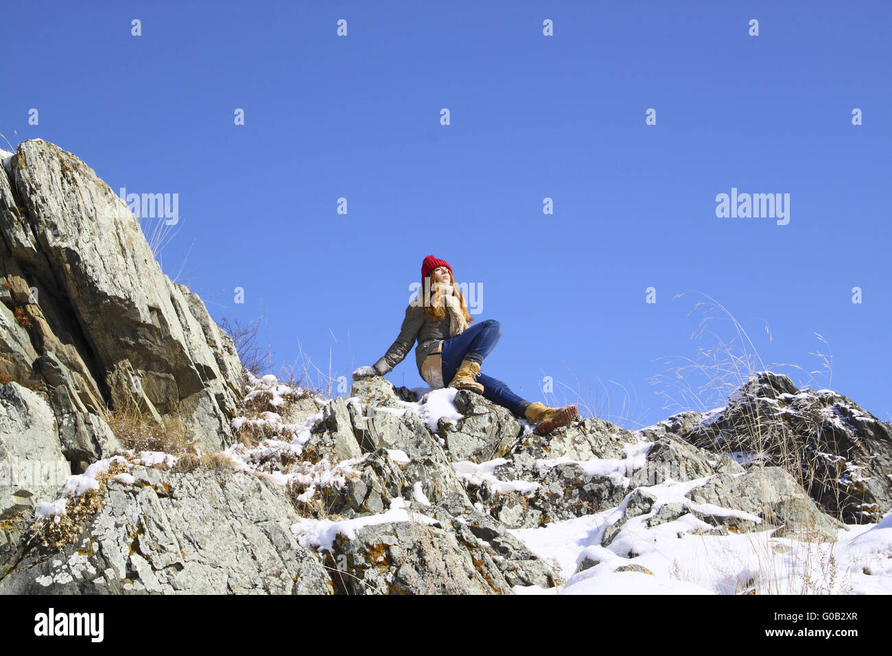 Young girl sitting on a rock and meditates Stock Photo - Alamy
