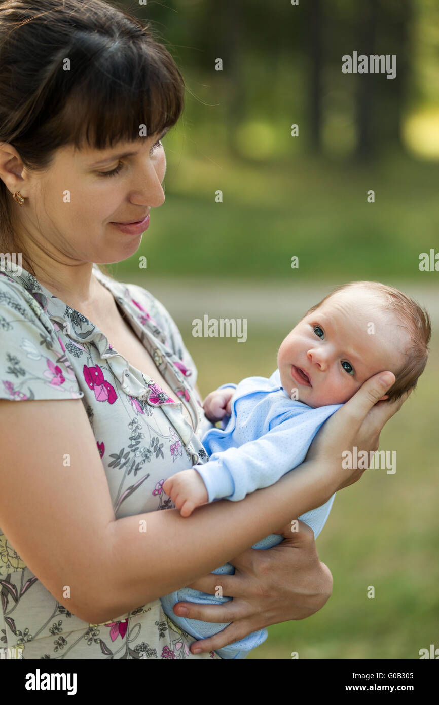Cute little newborn baby child on mother hands wal Stock Photo