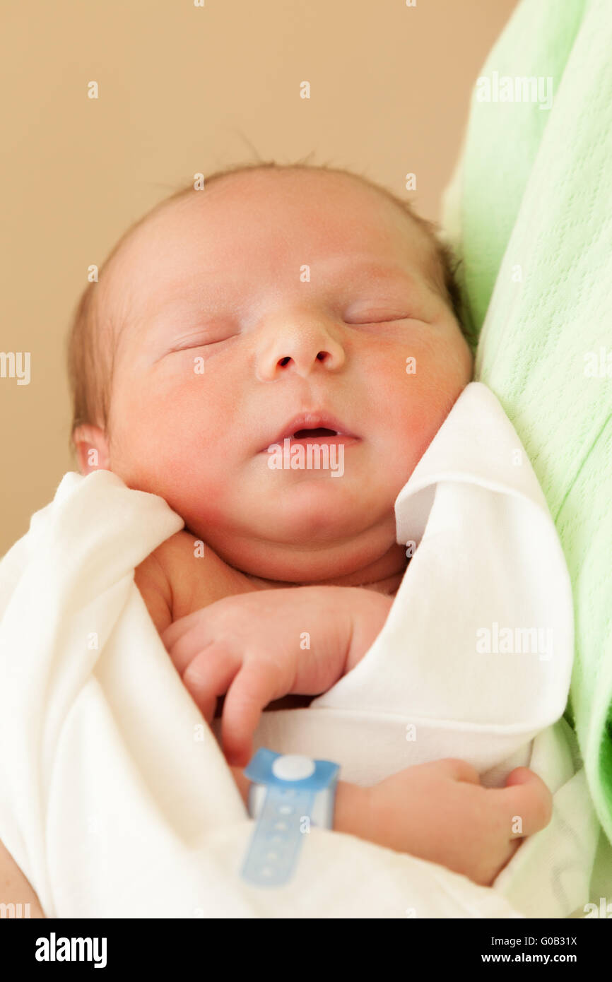 Cute sleeping newborn baby child on mother hands Stock Photo