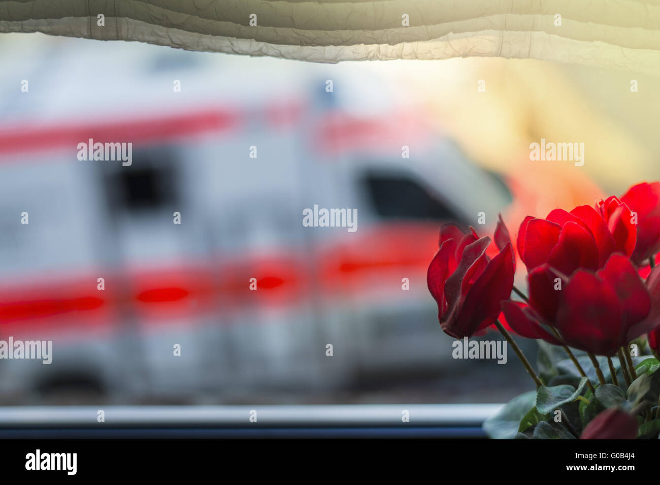 Ambulance is on the road outside the kitchen windo Stock Photo