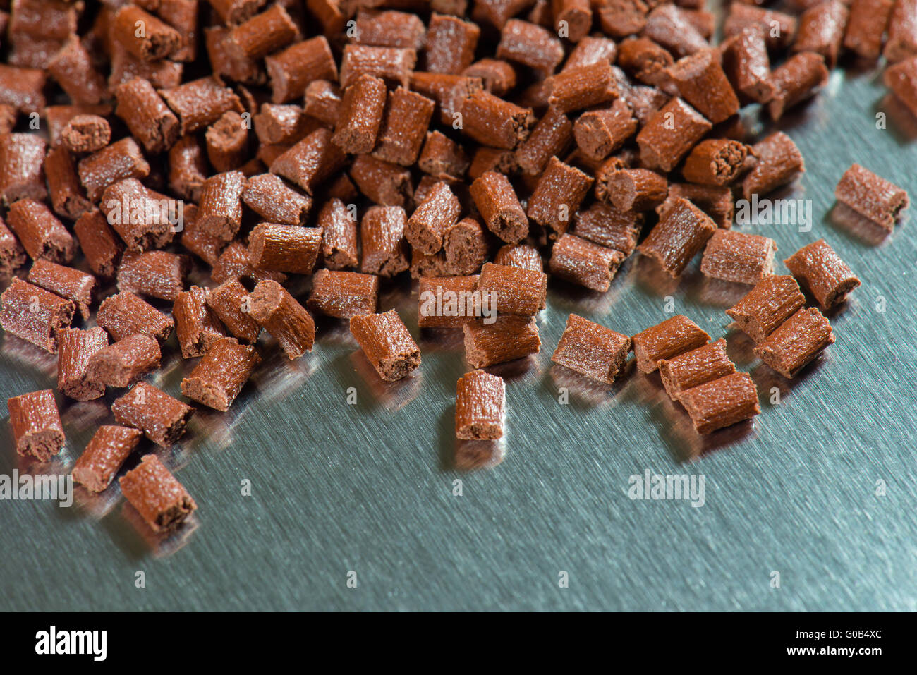 brown Ppolymer pellets on metal sheet Stock Photo