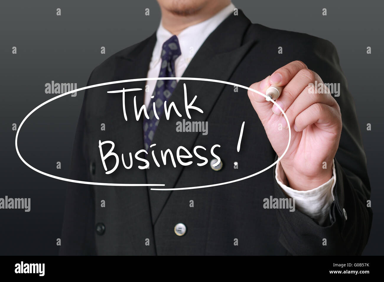 Business concept, image of a businessman holding marker and write Think Business words Stock Photo