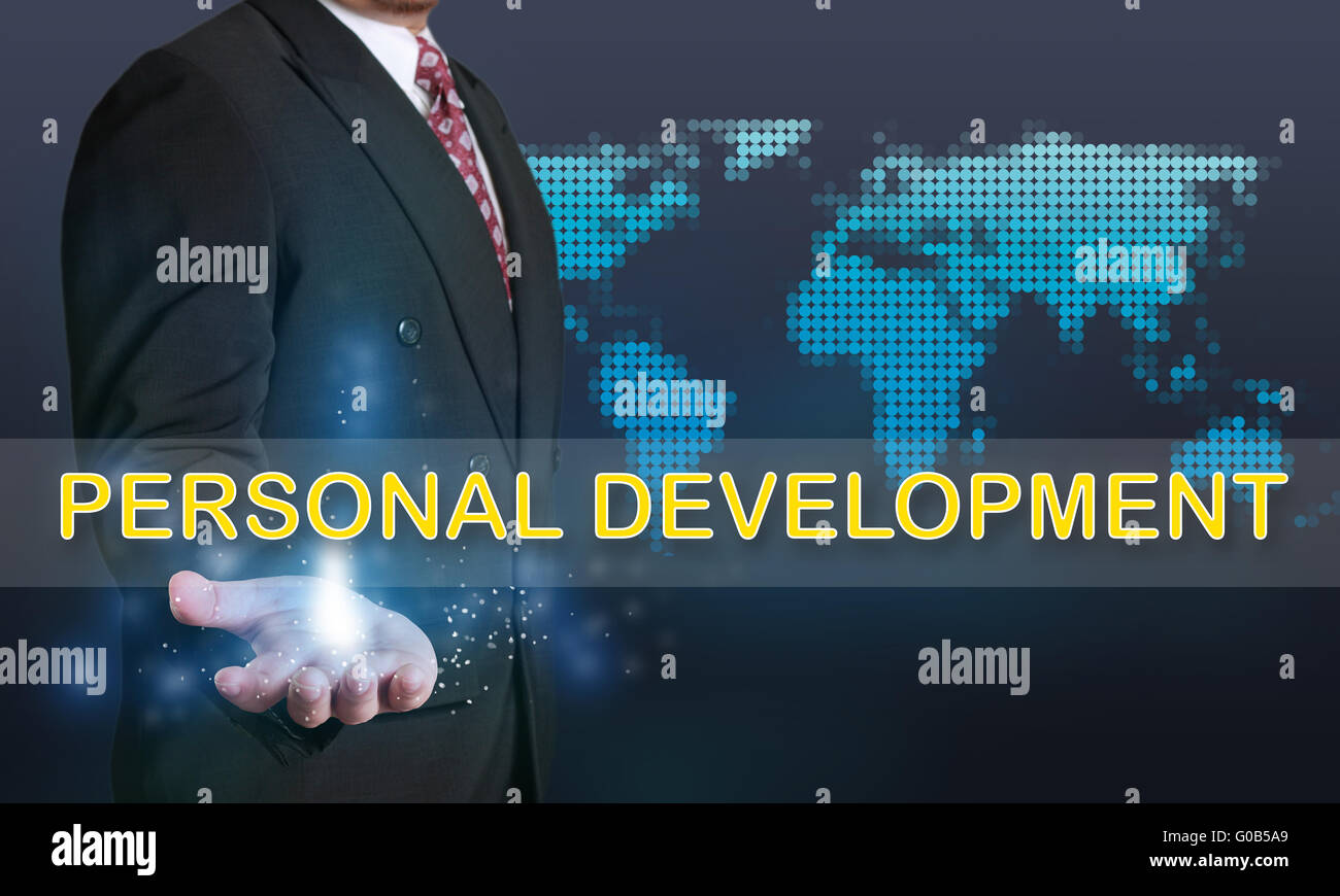 Business concept image of a businessman showing Personal Development words on his hand over blue background with dotted world ma Stock Photo