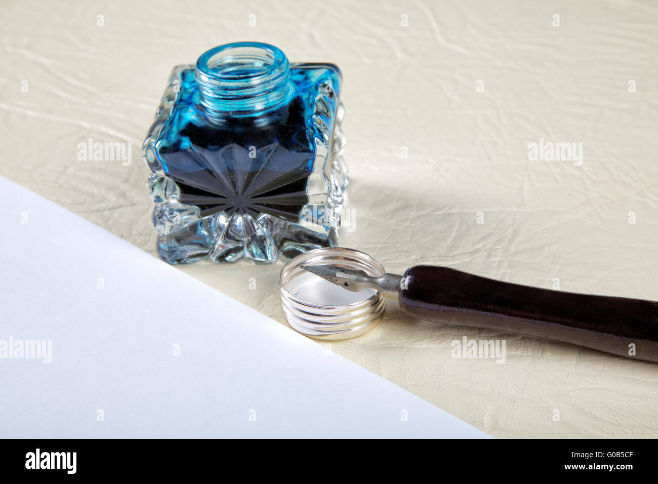 Ink pot and quill with sheets of paper on a table Stock Photo Alamy