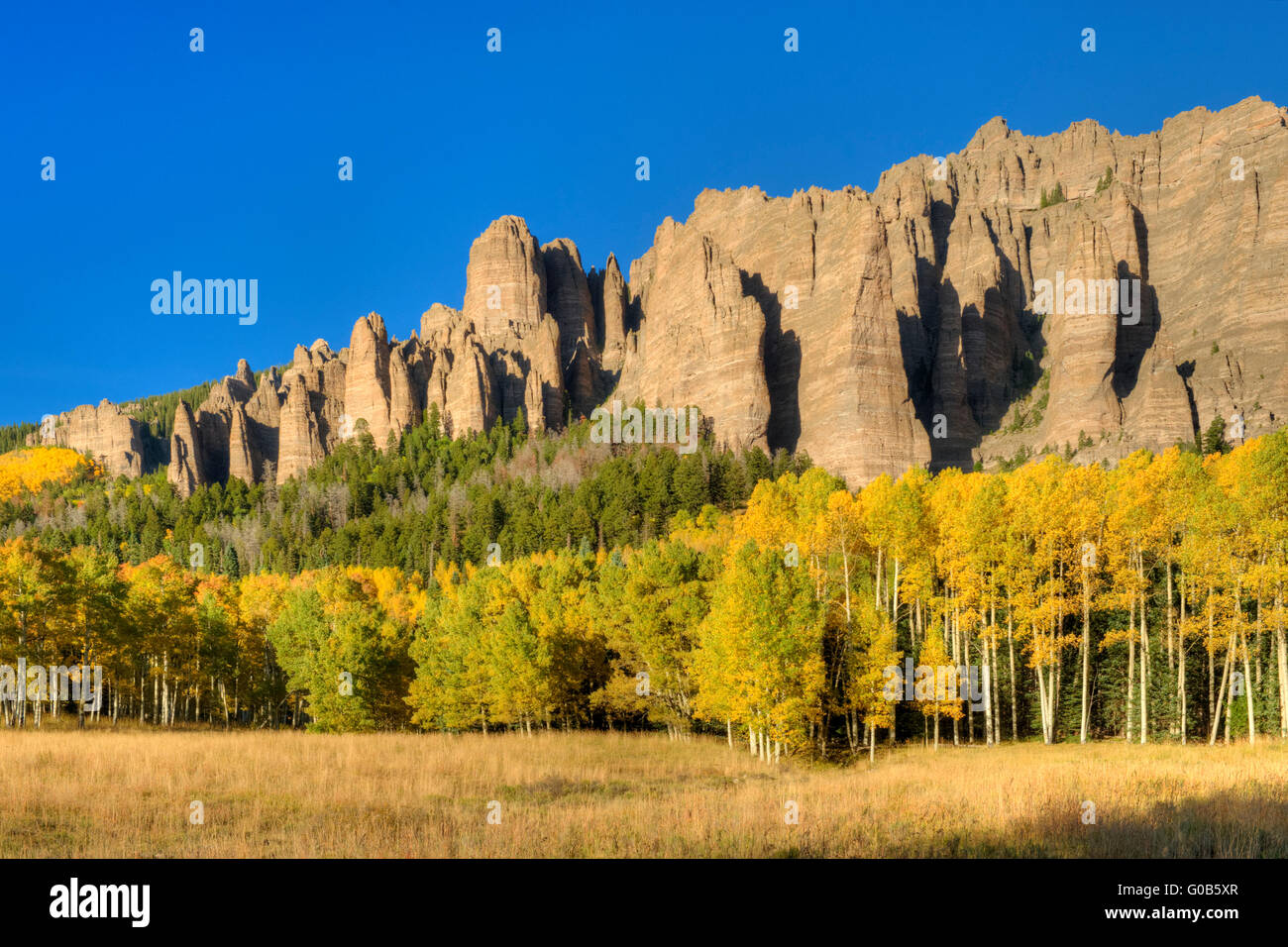 Pinnacles of welded volcanic tuff near Silverjack Lake, Colorado, in the San Juan Mountains, with aspens in full color Stock Photo