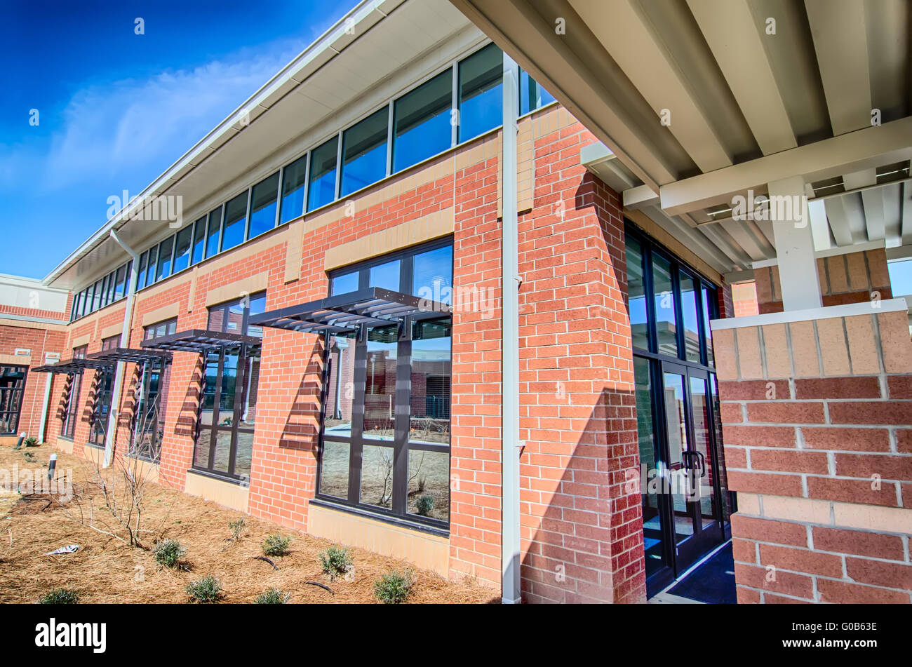 brick building architecture with suncreen shades on windows Stock Photo ...
