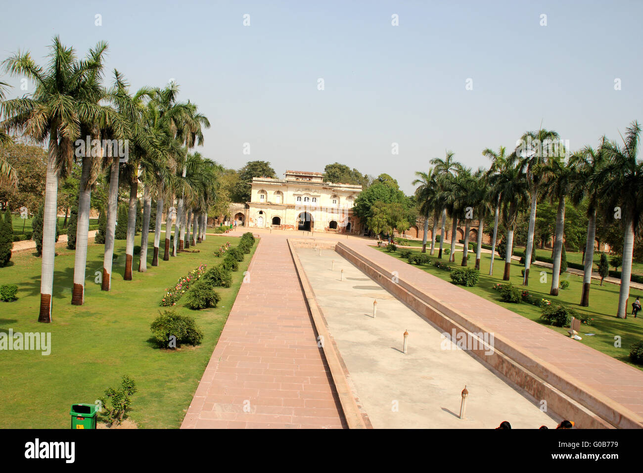Safdarjung Tomb, New Delhi, India, garden with two rows of royal palm and central canal, and main gate as seen from tomb Stock Photo