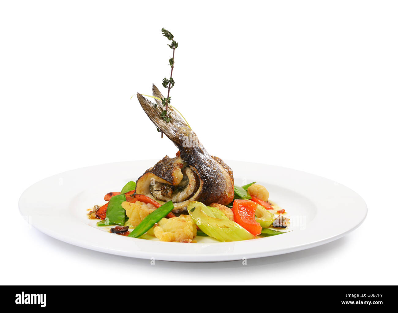 Sea bass fillet with spring vegetables and olive sauce Stock Photo Alamy