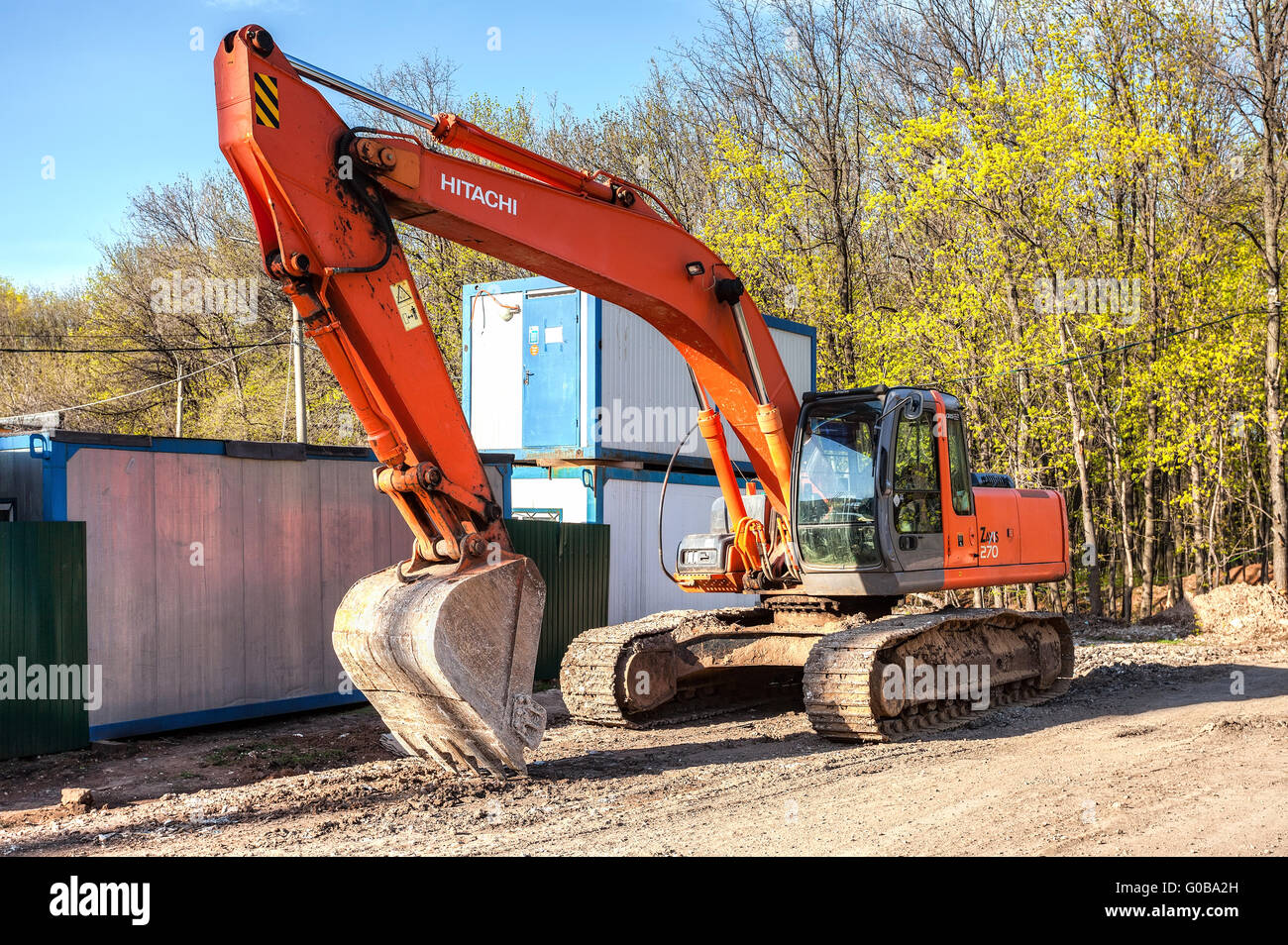 Excavator at construction site in summer sunny day Stock Photo - Alamy