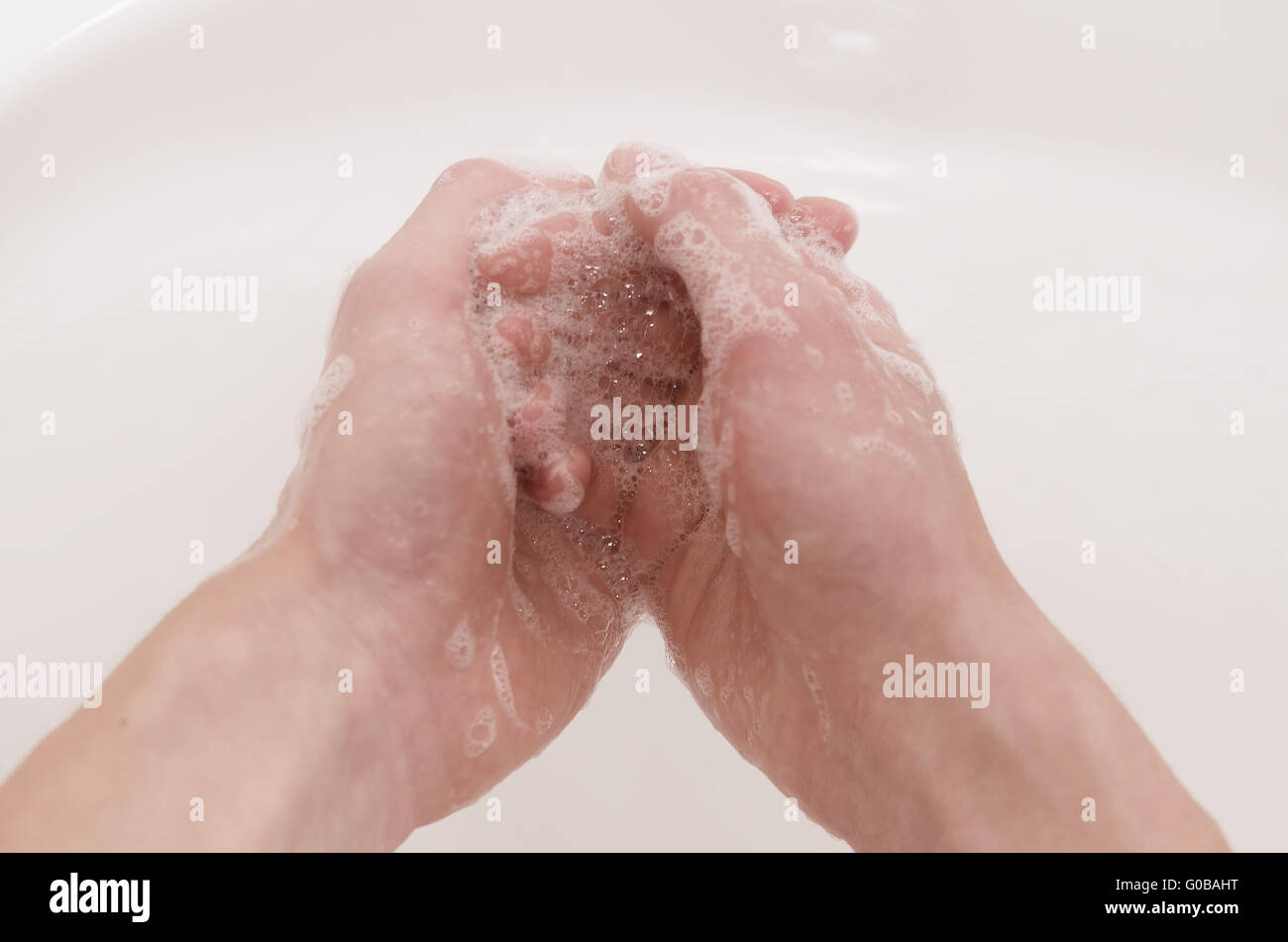 One hand washes the other Stock Photo