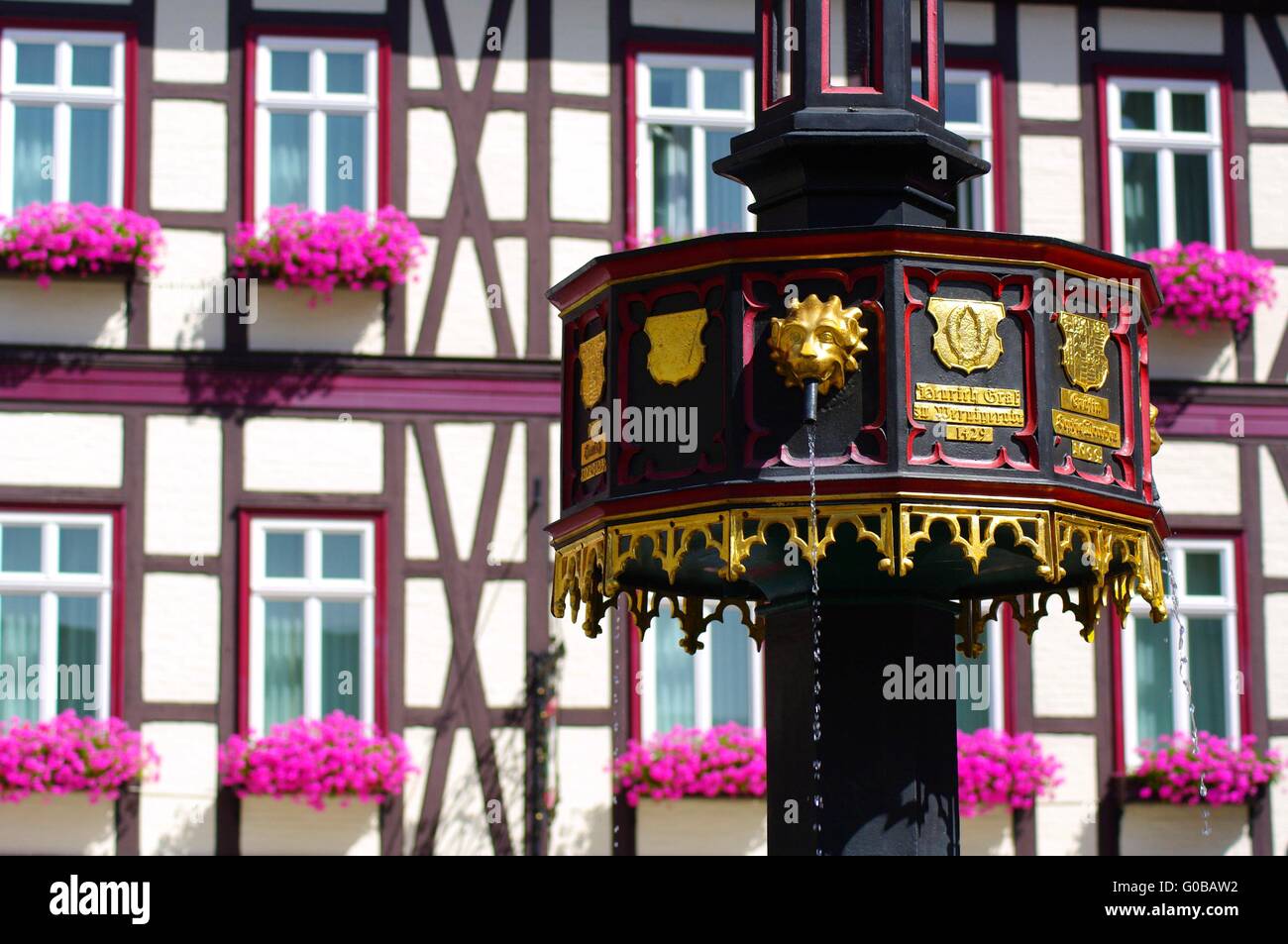 Half-timbered house with geraniums in the resin in Stock Photo