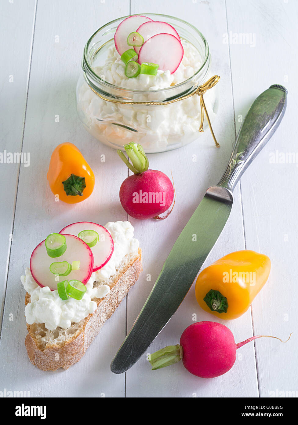 Cottage cheese with radishes and peppers on a tray Stock Photo