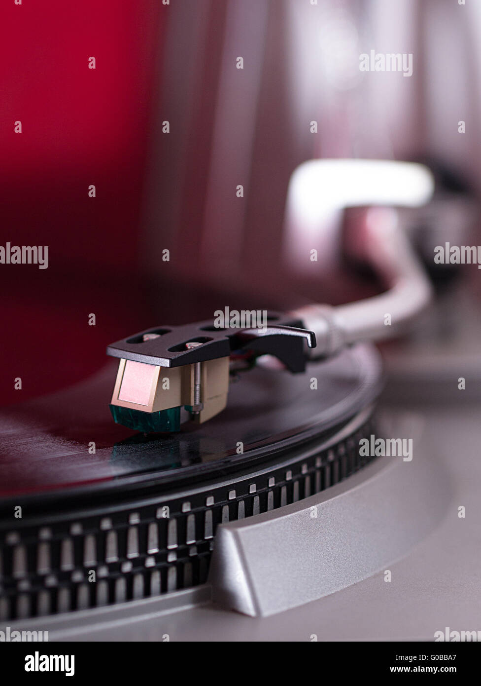 Pick-up arm of a record player which plays a recor Stock Photo