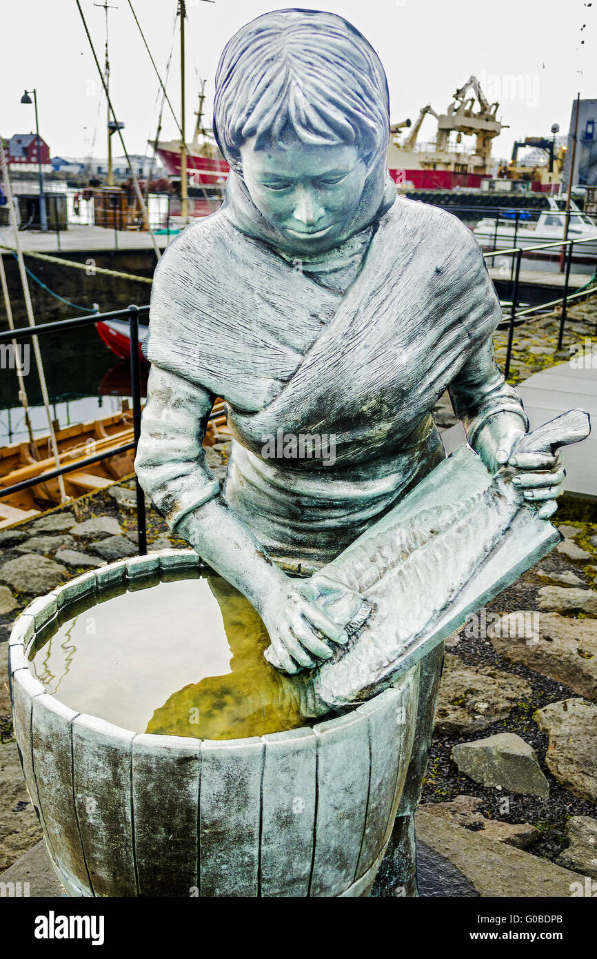 Statue Of Girl Cleaning A Fish Torshavn Faroe Isla Stock Photo