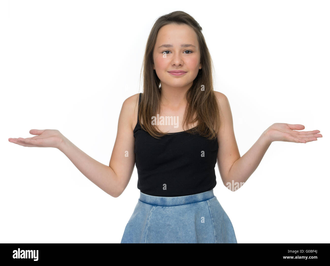 Cute smiling young girl shrugging her shoulders Stock Photo Alamy
