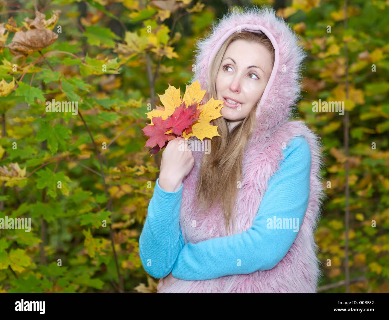 woman in autumn park with an armful of maple leave Stock Photo - Alamy