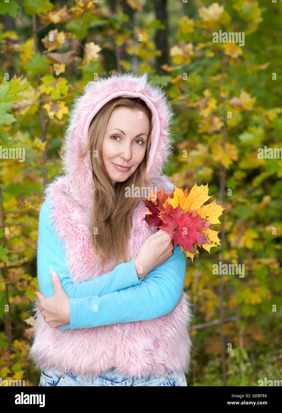 beautiful woman in autumn park with maple leaves Stock Photo - Alamy