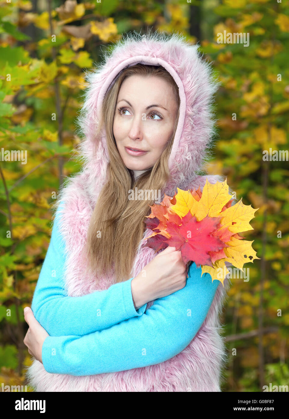 woman in autumn park with an armful of maple leave Stock Photo - Alamy