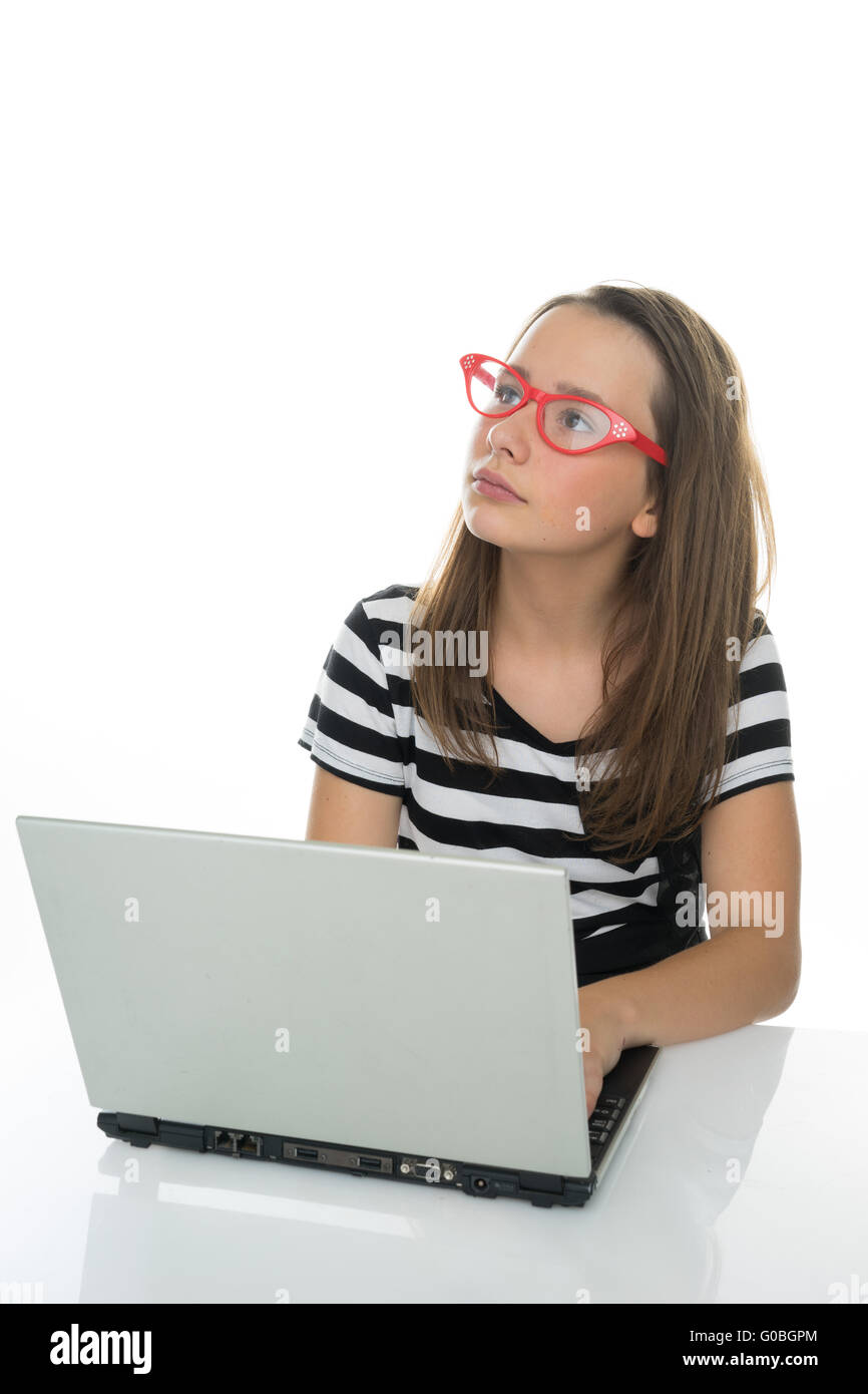 Serious young girl working at a laptop computer Stock Photo - Alamy