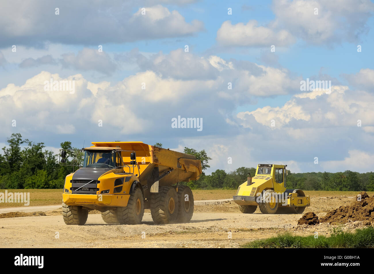 Dump truck tire roller and at construction site Stock Photo