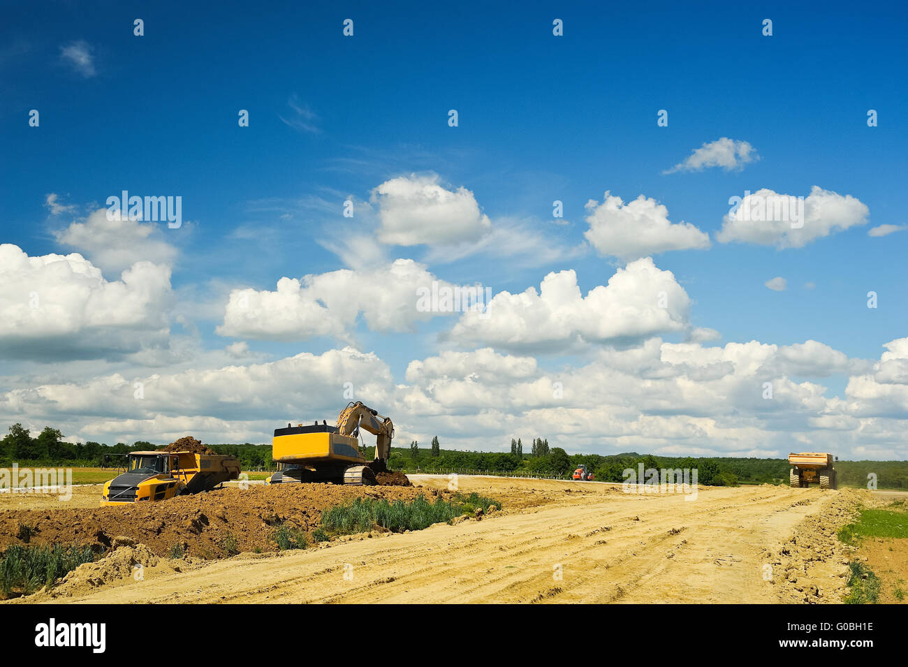 Dump Truck with Excavator on construction site Stock Photo