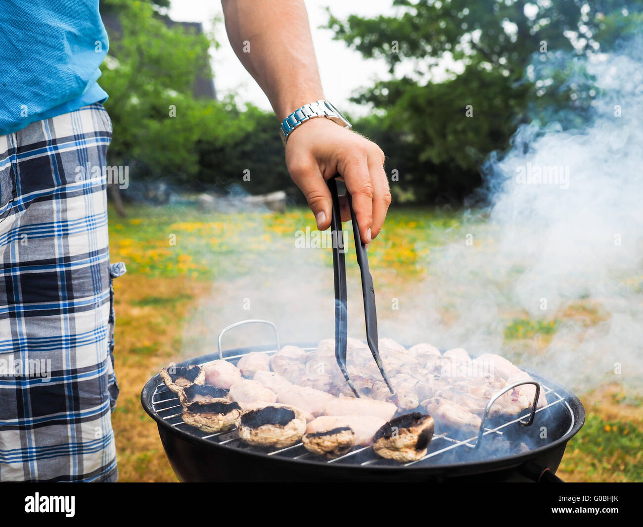 Chef barbecuing with lots of smoke Stock Photo