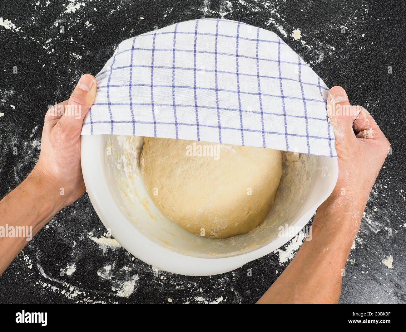 Proofing dough under towel Stock Photo