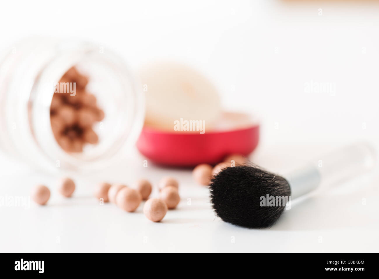 Composition of bronzing pearls and makeup brush horizontal Stock Photo