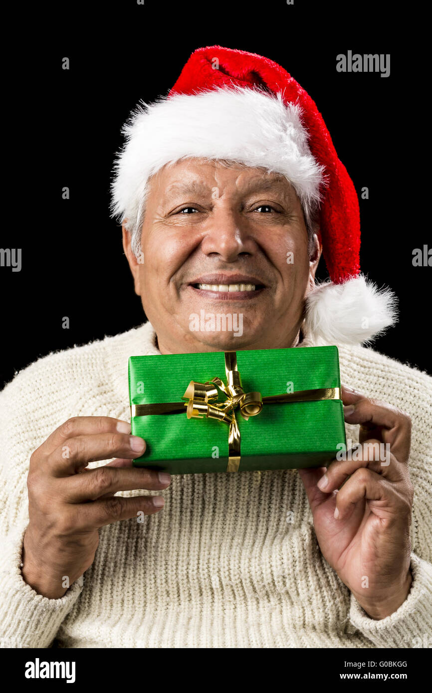 Smiling Old Man Handing Over A Wrapped Green Gift Stock Photo