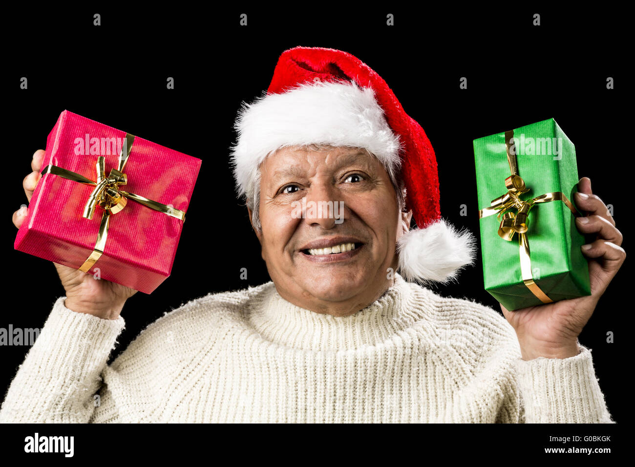 Poignant Aged Man Showing Red And Green Xmas Gifts Stock Photo