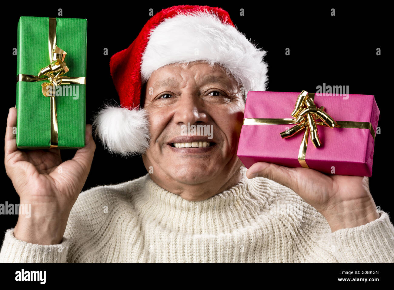 Kind Aged Gentleman With Red Cap Raising Two Gifts Stock Photo