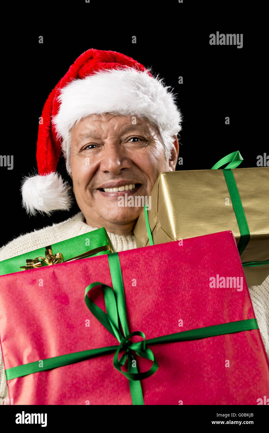 Aged Gentleman Peering Across Three Wrapped Gifts Stock Photo