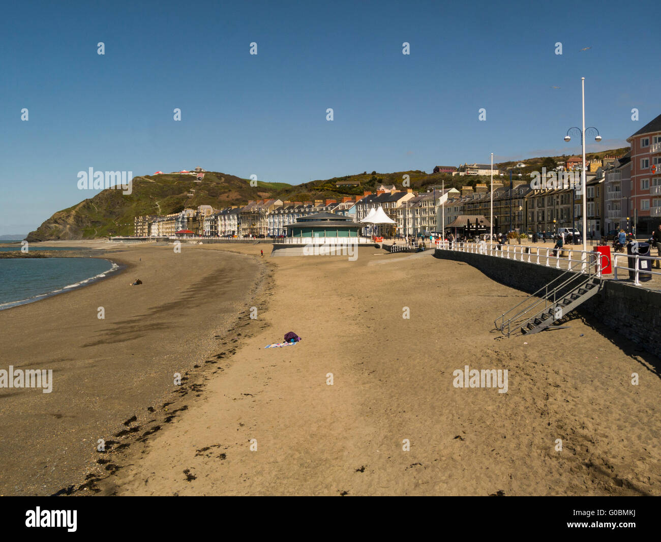 Looking along sandy beach of Aberystwyth sea front to Cliff Railway