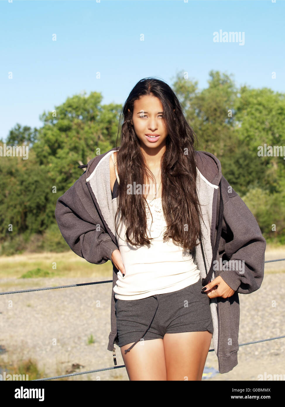 Young woman of mixed ethnicity outdoors in shorts Stock Photo - Alamy
