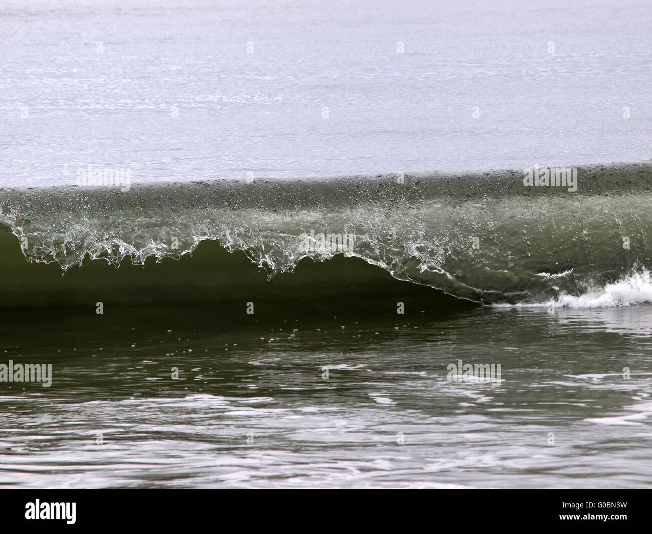 Shot Of Ocean Wave Curling Over California Coast Stock Photo