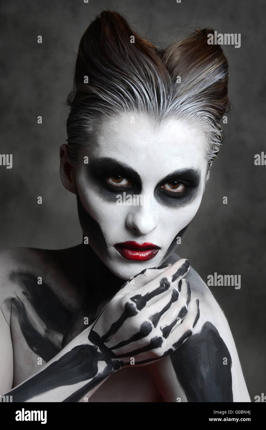 young woman with dead mask skull face art halloween face stock image
