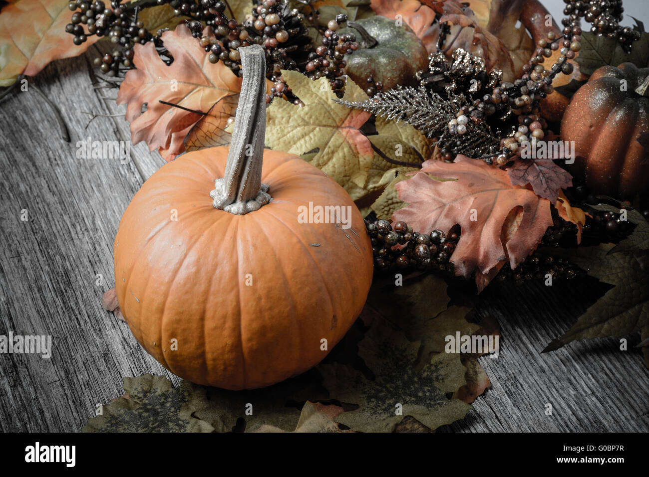 Pumpkin and Fall Leaves on Rustic Wood Background Stock Photo - Alamy