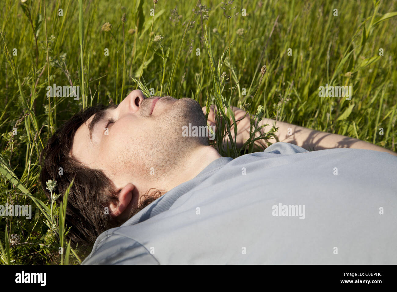 Man sleeping in field hi-res stock photography and images - Alamy