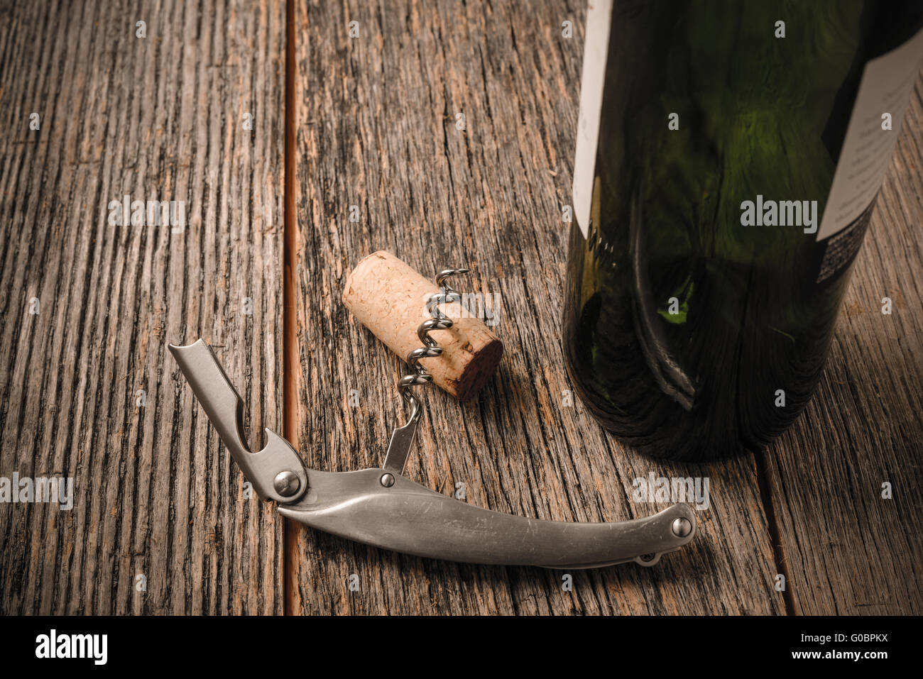 Green Wine Bottle and Cork with Red Wine and corkscrew Stock Photo Alamy