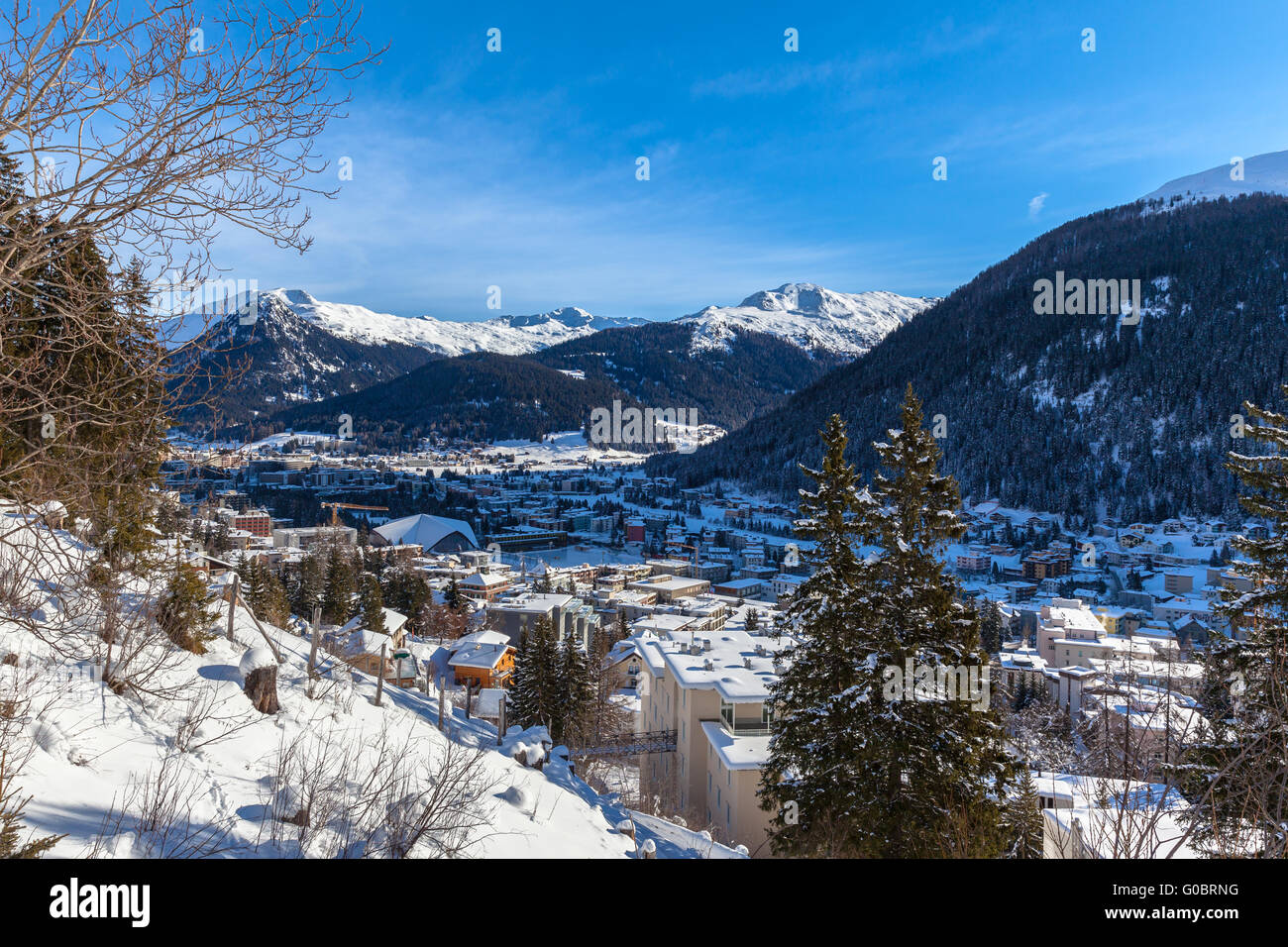 Aerial view of Davos in Winter with snow covered roofs and the Alps