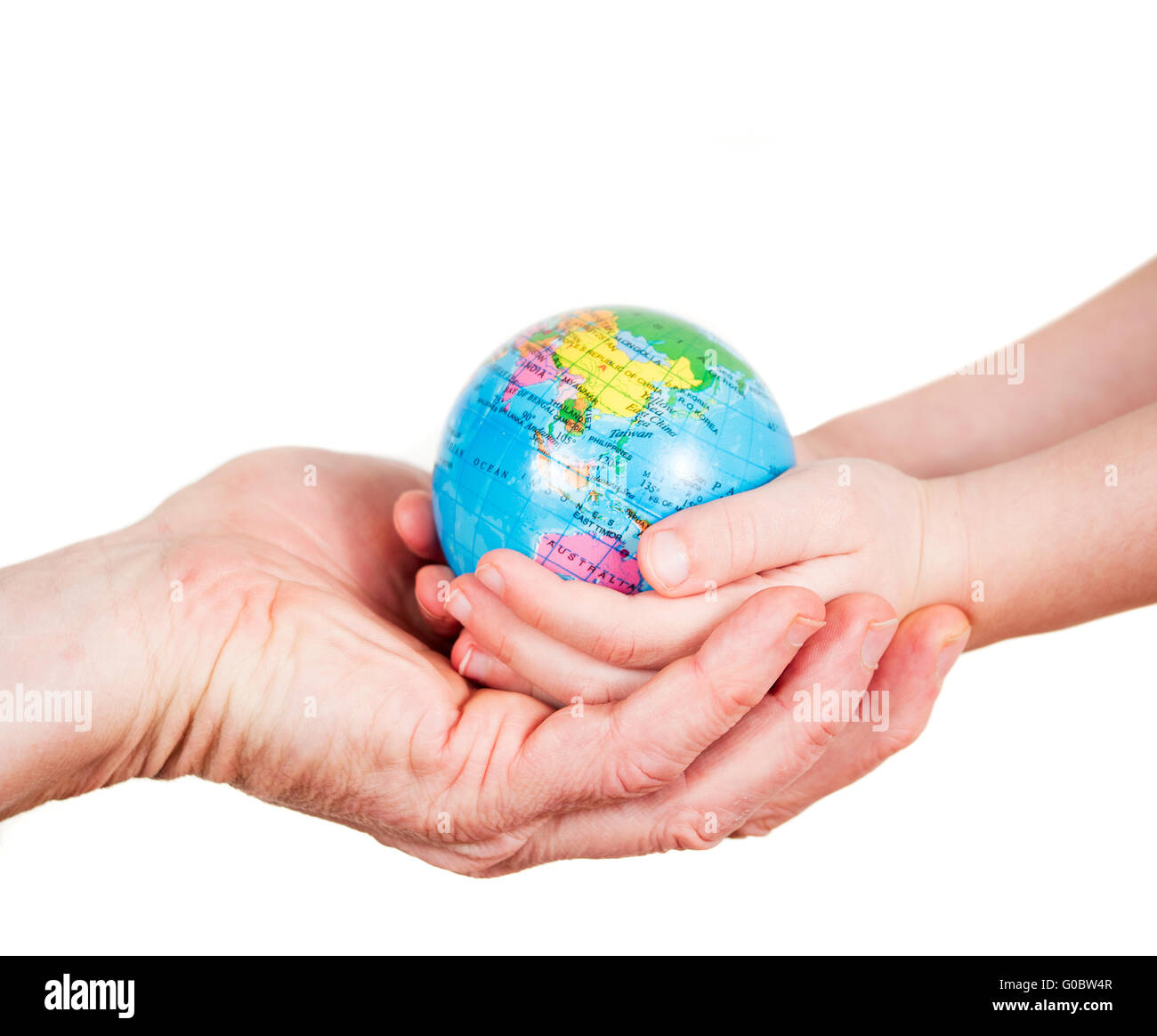 Hands of a child and a man holding a globe Stock Photo