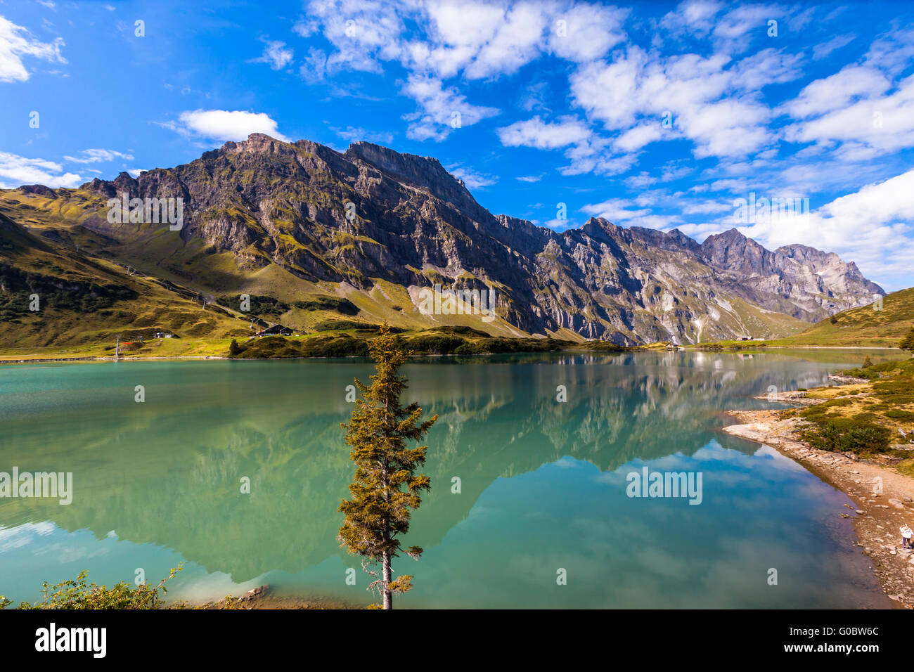 Panorama view of Truebsee (lake) on a sunny summer day with Braustock in background and beautiful reflection in water, canton of Stock Photo