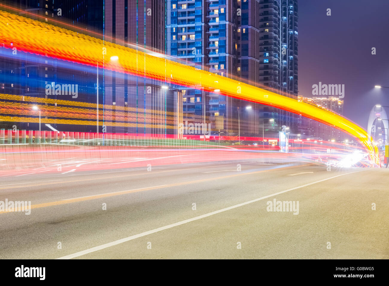 city road at night with dramatic light trails Stock Photo