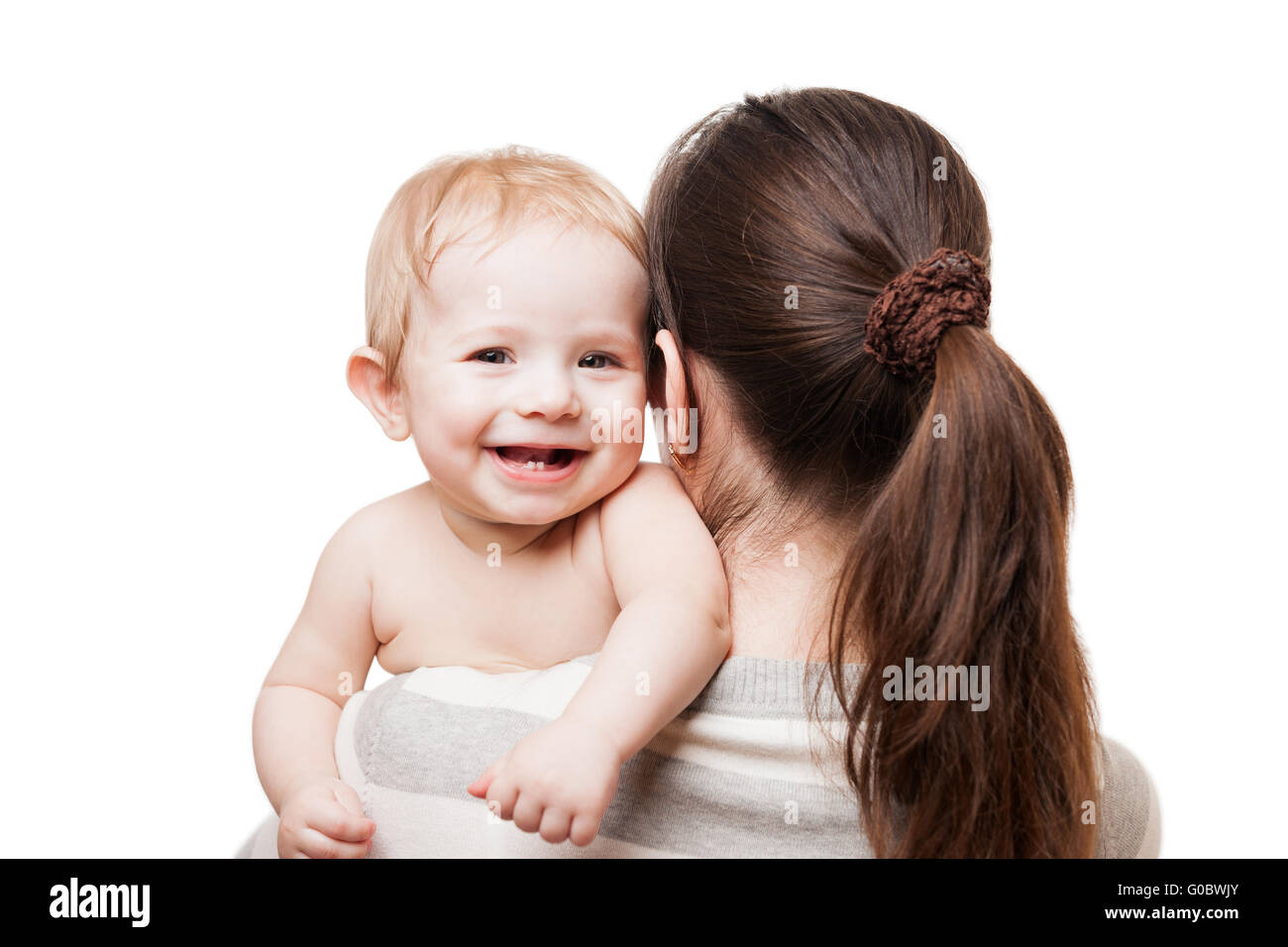 Loving mother holding little newborn smiling baby Stock Photo