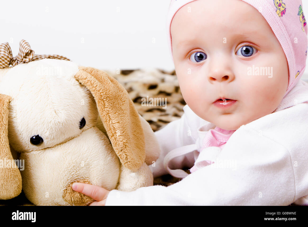 blueeyed baby with a soft toy. studio photo Stock Photo Alamy
