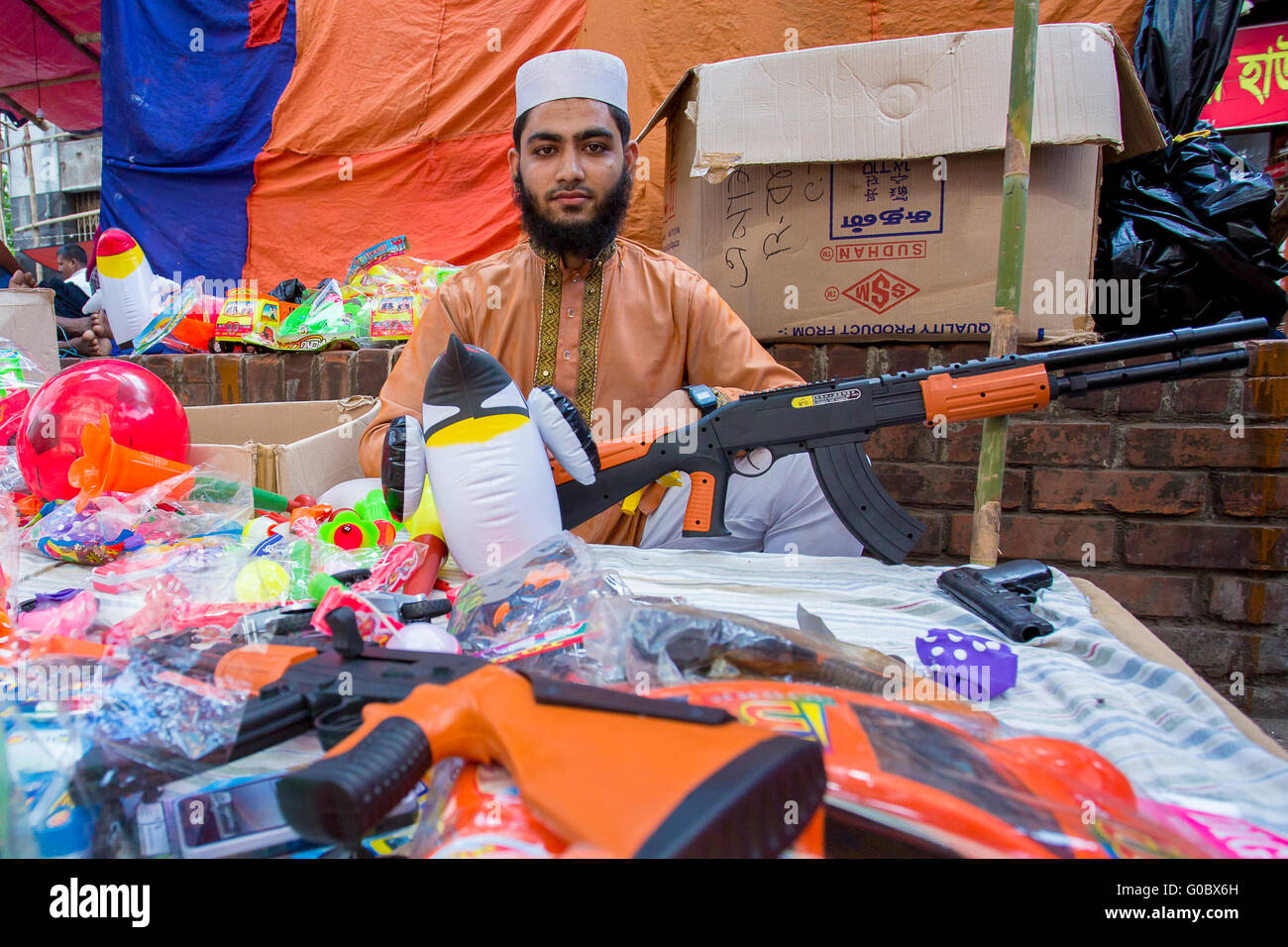 A Man sells toys, toygun on the occasion of Jabbar er Boli khela at